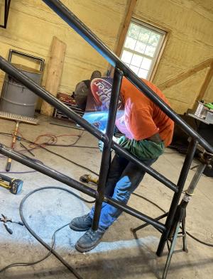 Welder welding railing for stairs